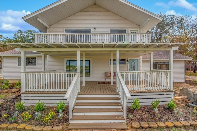 view of front of home featuring a porch and a balcony