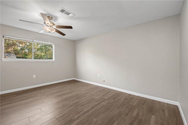 unfurnished room with dark hardwood / wood-style floors and ceiling fan