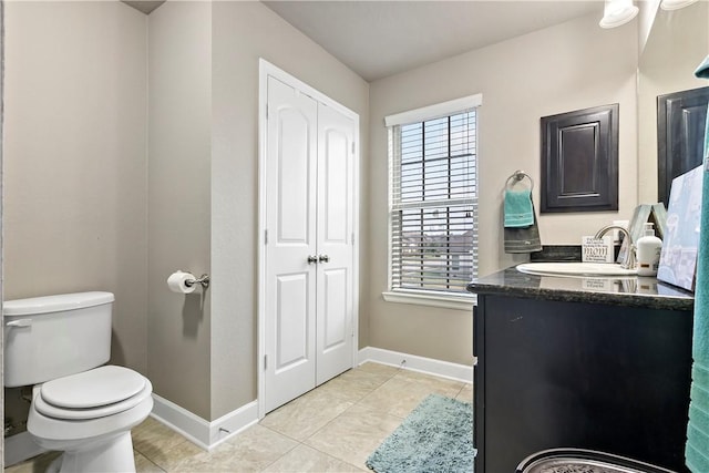 bathroom featuring tile patterned floors, vanity, and toilet