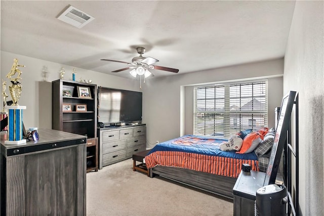 bedroom with ceiling fan and light carpet