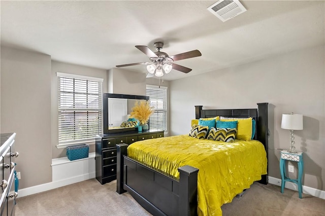 bedroom featuring light colored carpet and ceiling fan