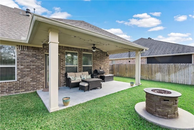 exterior space with ceiling fan, a patio area, and an outdoor living space with a fire pit