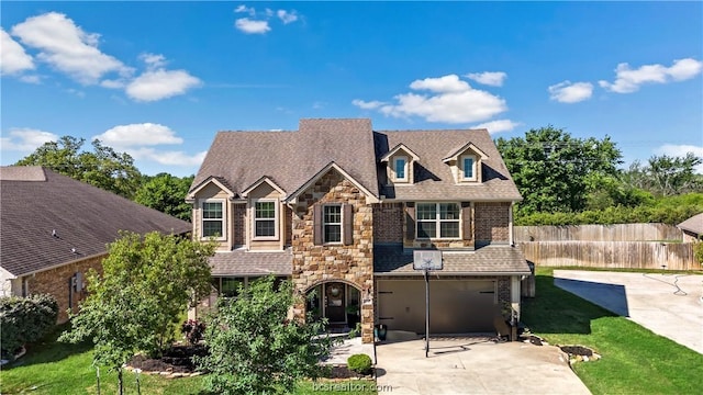 view of front of property with a garage and a front lawn