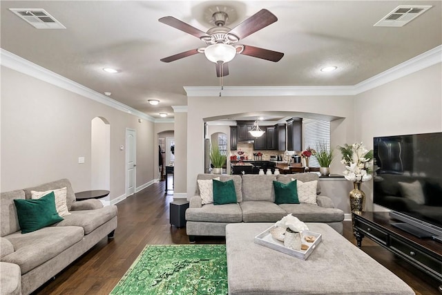 living room featuring ceiling fan, dark hardwood / wood-style floors, and ornamental molding