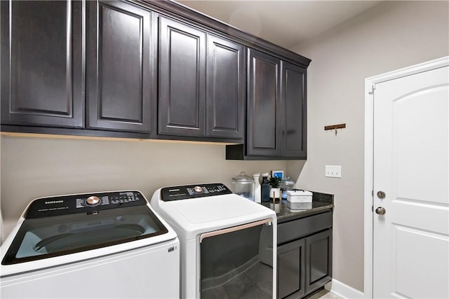 clothes washing area with cabinets and independent washer and dryer