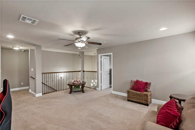 sitting room with light carpet and ceiling fan