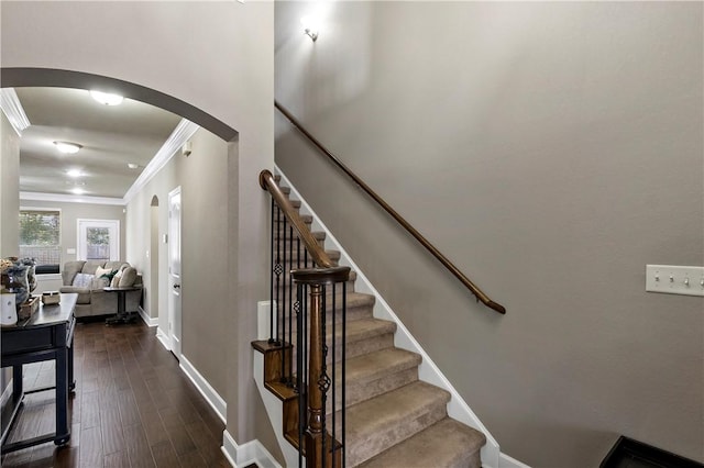 staircase with hardwood / wood-style flooring and ornamental molding