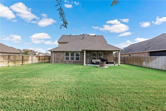 back of property featuring outdoor lounge area, a patio, and a lawn