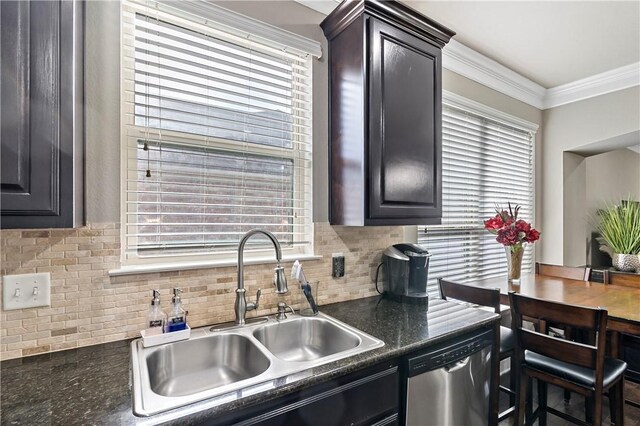 kitchen featuring dishwasher, decorative backsplash, crown molding, and sink