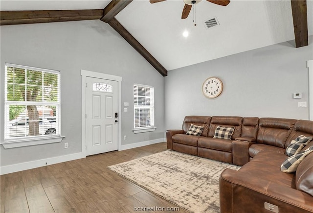 living room with ceiling fan, beam ceiling, high vaulted ceiling, and light hardwood / wood-style flooring