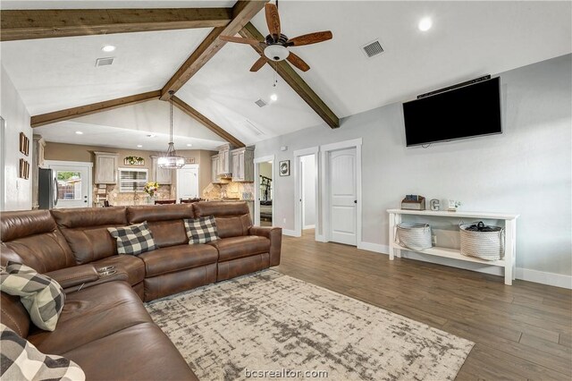 living room with lofted ceiling with beams, ceiling fan, and dark wood-type flooring