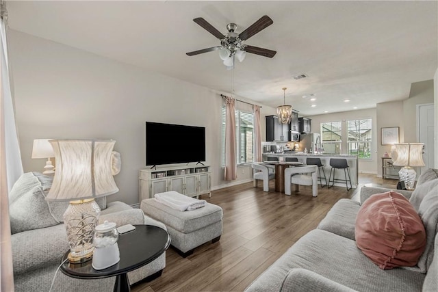 808 Mineral Wells Ln, College Station, TX 77845 - living room with a ceiling fan, wood finished floors, recessed lighting, and a chandelier