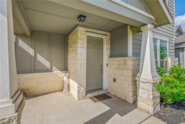 808 Mineral Wells Ln, College Station, TX 77845 - property entrance featuring stone siding, board and batten siding, and a porch