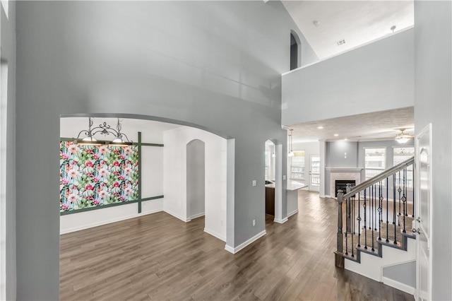 interior space with a high ceiling and hardwood / wood-style floors