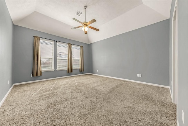 empty room with ceiling fan, vaulted ceiling, and carpet