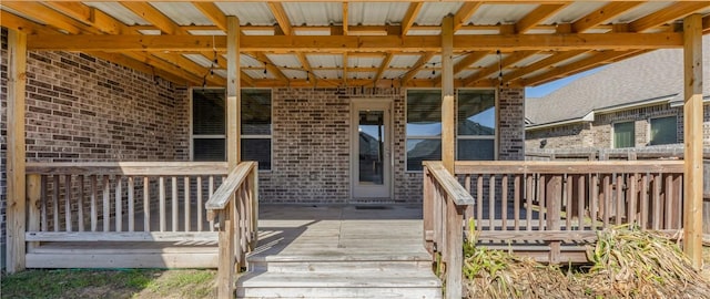 view of exterior entry with a deck