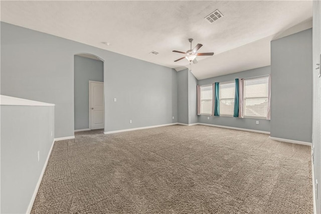 unfurnished room with vaulted ceiling, carpet flooring, and ceiling fan