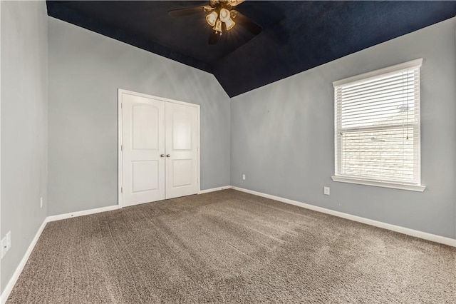 spare room with lofted ceiling, ceiling fan, and carpet flooring