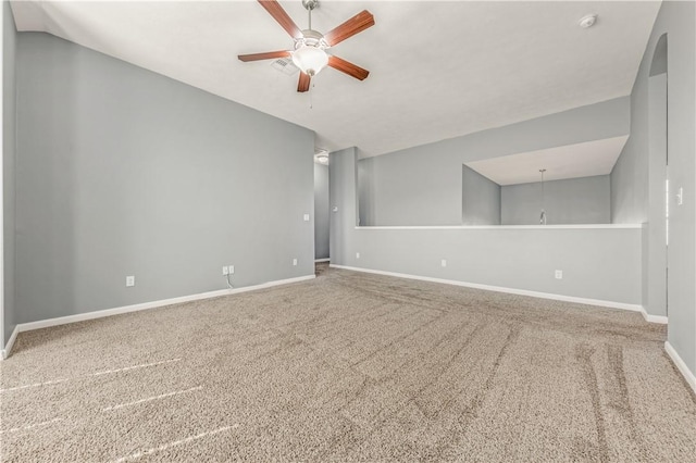 carpeted spare room featuring lofted ceiling and ceiling fan