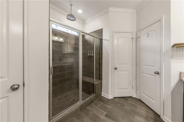 bathroom with hardwood / wood-style floors, ornamental molding, and walk in shower