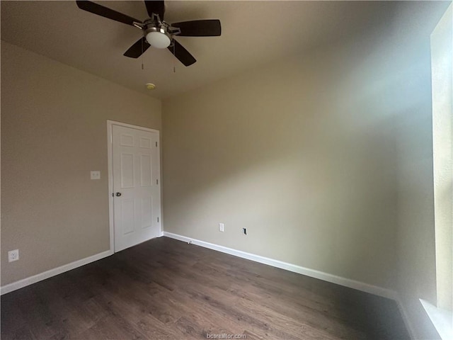 spare room featuring ceiling fan and dark hardwood / wood-style flooring