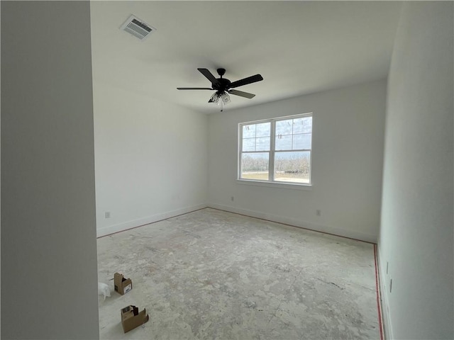 spare room featuring baseboards, visible vents, and ceiling fan