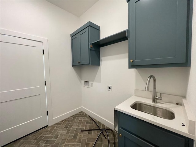 clothes washing area featuring washer hookup, cabinet space, a sink, electric dryer hookup, and baseboards