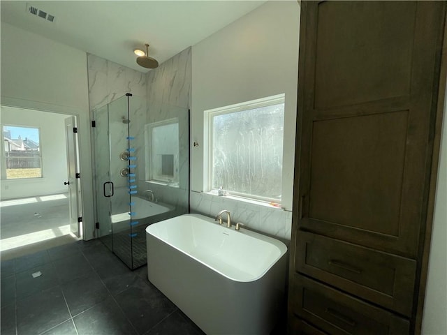 full bathroom with a freestanding tub, a marble finish shower, visible vents, and a healthy amount of sunlight