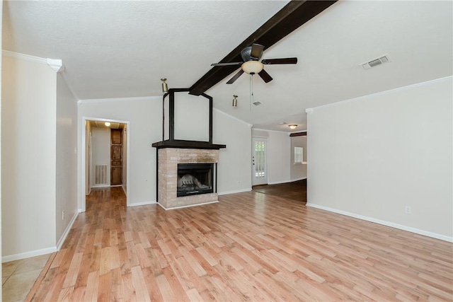 unfurnished living room featuring lofted ceiling with beams, light hardwood / wood-style flooring, ceiling fan, and ornamental molding