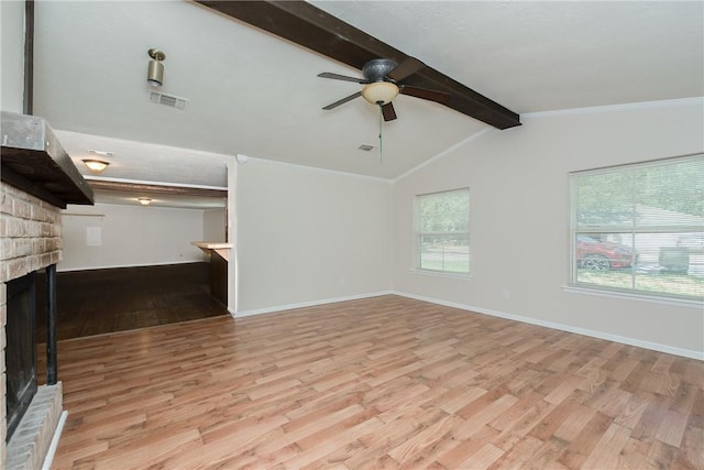 unfurnished living room featuring ceiling fan, light hardwood / wood-style flooring, lofted ceiling with beams, and a brick fireplace