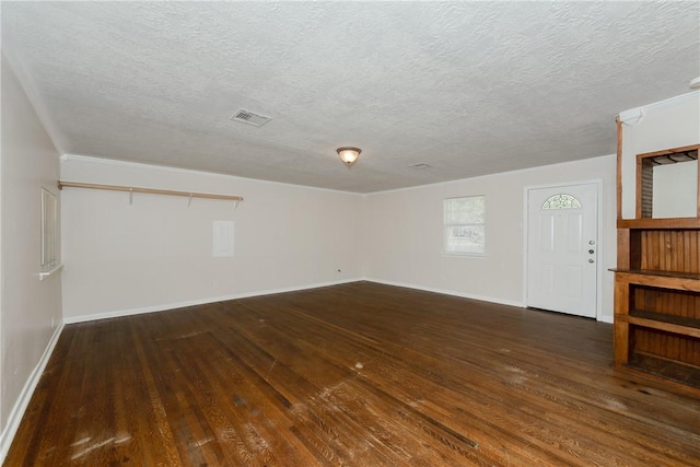 interior space with a textured ceiling and dark hardwood / wood-style floors