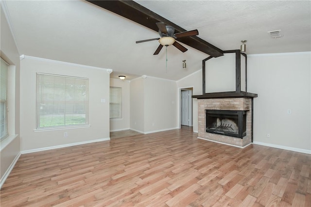 unfurnished living room featuring a fireplace, lofted ceiling with beams, light hardwood / wood-style floors, and ceiling fan