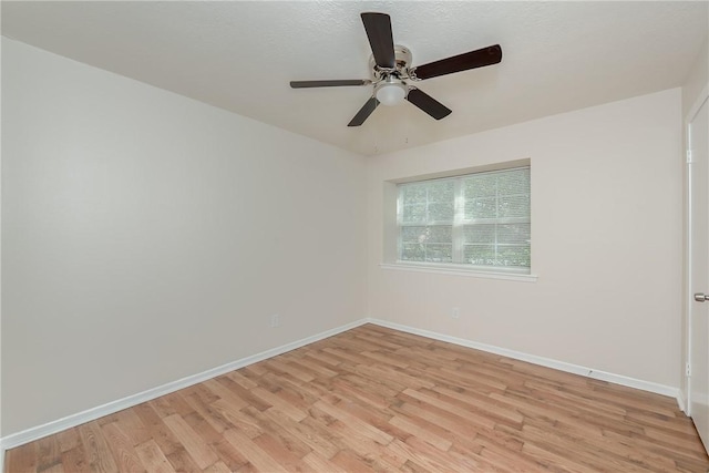 spare room featuring ceiling fan and light wood-type flooring