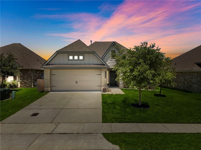 3860 Still Creek Loop, College Station, TX 77845 - view of front of house with board and batten siding, a garage, a yard, and concrete driveway