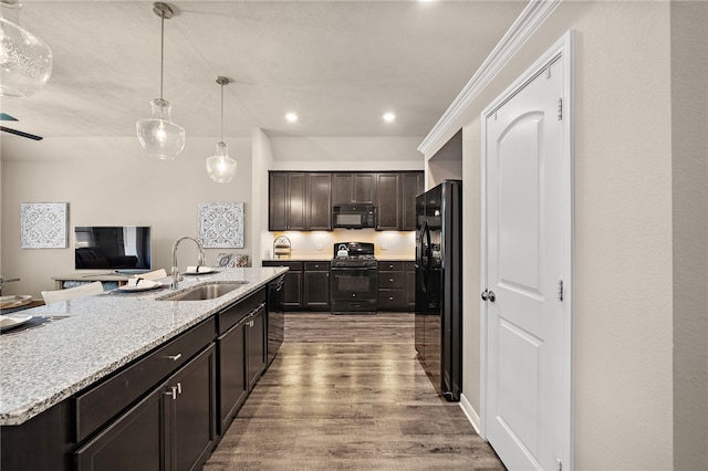 3860 Still Creek Loop, College Station, TX 77845 - kitchen with black appliances, a sink, light wood-style floors, hanging light fixtures, and dark brown cabinets