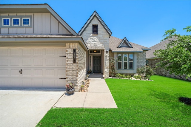 3860 Still Creek Loop, College Station, TX 77845 - view of front of house with board and batten siding, a front yard, brick siding, concrete driveway, and roof with shingles