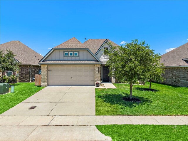 3860 Still Creek Loop, College Station, TX 77845 - view of front of property featuring board and batten siding, a front lawn, driveway, and an attached garage