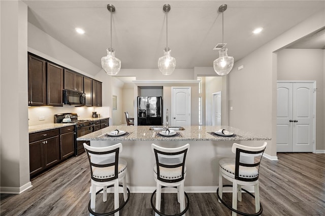 3860 Still Creek Loop, College Station, TX 77845 - kitchen featuring black appliances, a sink, dark brown cabinets, a kitchen bar, and recessed lighting