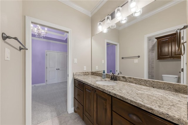 bathroom with crown molding, vanity, toilet, baseboards, and tile patterned floors
