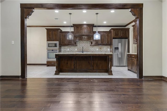 kitchen featuring stainless steel appliances, light wood finished floors, crown molding, baseboards, and dark brown cabinets