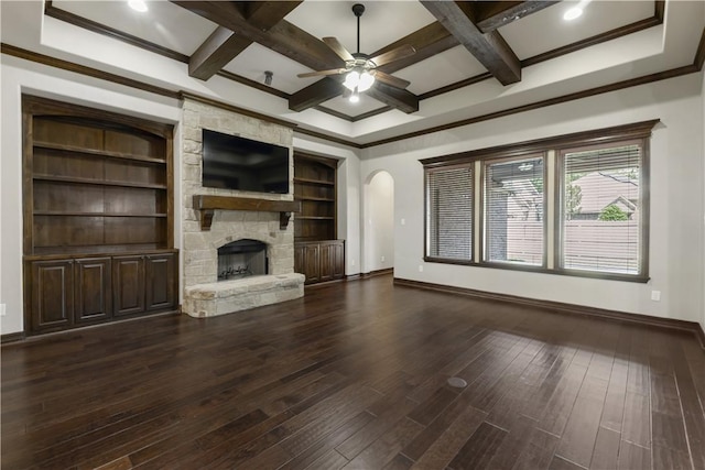 unfurnished living room featuring coffered ceiling, baseboards, a ceiling fan, dark wood finished floors, and beam ceiling