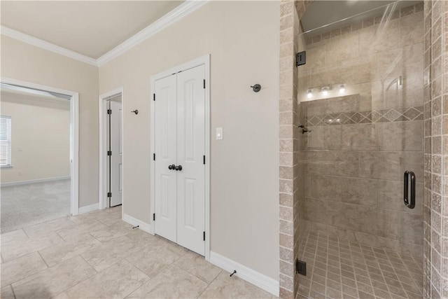 full bath with ornamental molding, a stall shower, and baseboards