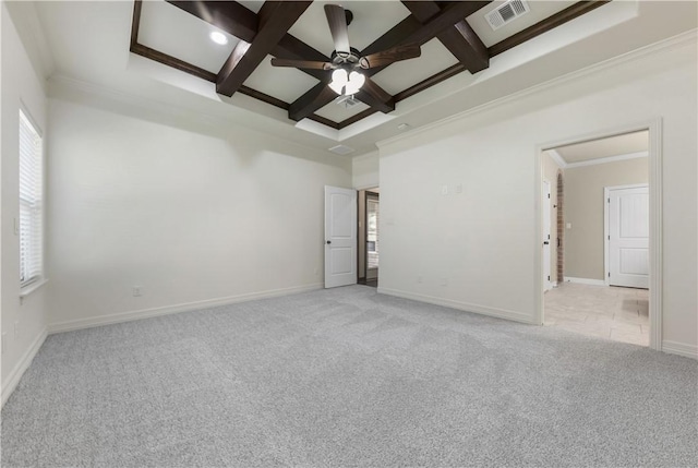 spare room featuring light carpet, plenty of natural light, ceiling fan, coffered ceiling, and beam ceiling