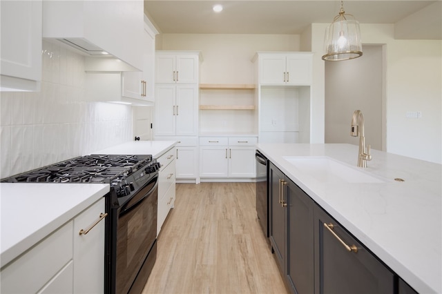 2802 Spector Dr, Bryan, TX 77808 - kitchen featuring gas stove, a sink, light wood-style flooring, and light countertops