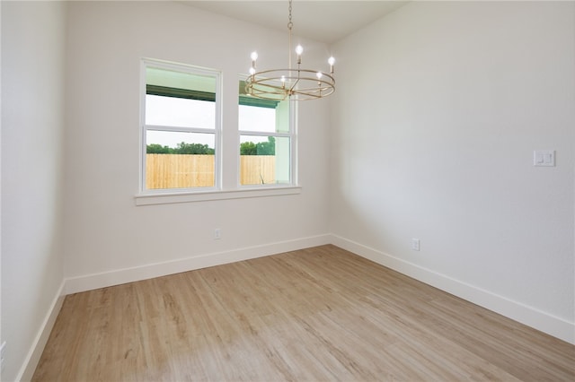 2802 Spector Dr, Bryan, TX 77808 - empty room with a chandelier, light wood finished floors, and baseboards