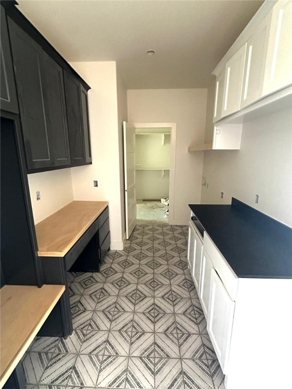 kitchen with baseboards and dark cabinets