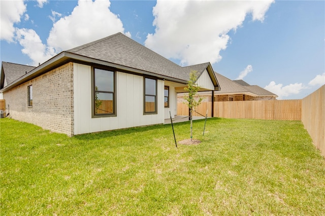 2802 Spector Dr, Bryan, TX 77808 - rear view of house featuring a shingled roof, brick siding, and board and batten siding