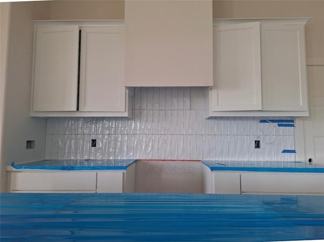 kitchen featuring white cabinets and decorative backsplash