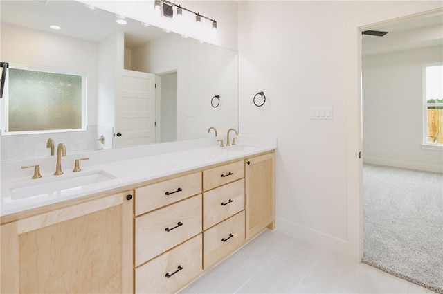 2802 Spector Dr, Bryan, TX 77808 - bathroom featuring double vanity, tile patterned flooring, and baseboards