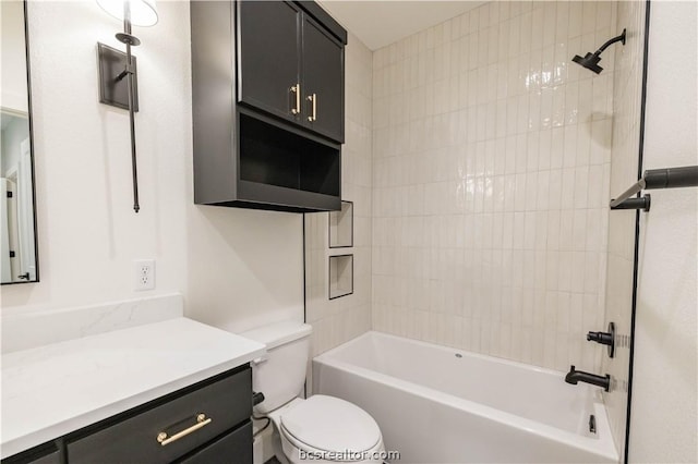 full bathroom featuring vanity, tiled shower / bath combo, and toilet